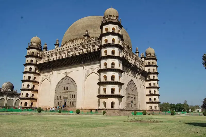 A majestic fortress with towering walls and ornate architecture, representing the grandeur of the Deccan Sultanate.
