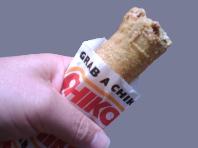 Chiko Rolls being deep-fried to a perfect golden brown in a hot pan.