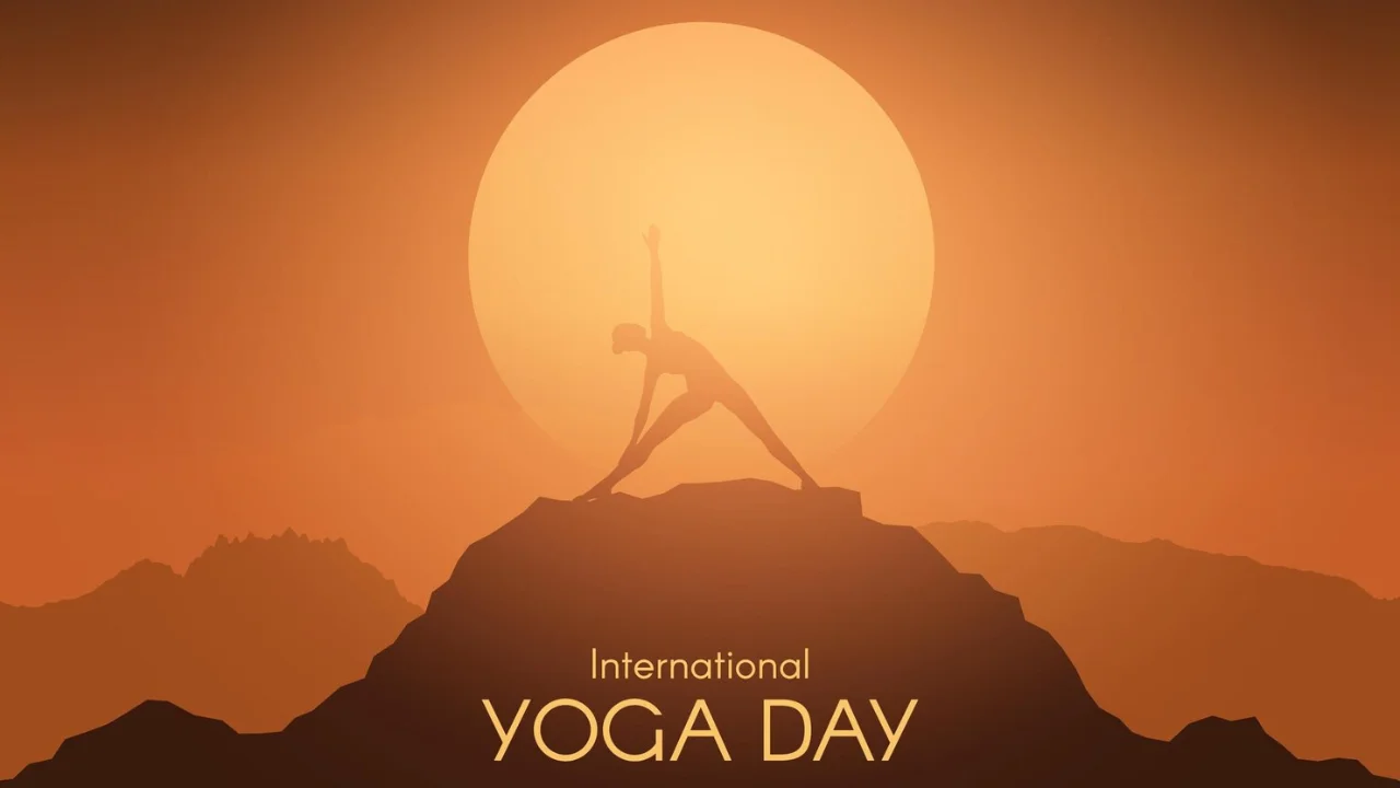 A group of people practicing yoga at sunrise to celebrate International Yoga Day.