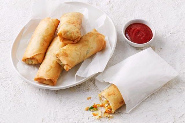 Close-up of a freshly made Chiko Roll, revealing its beef and vegetable filling.