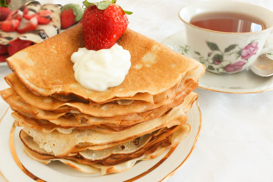Stack of blini served with smoked salmon and dill 