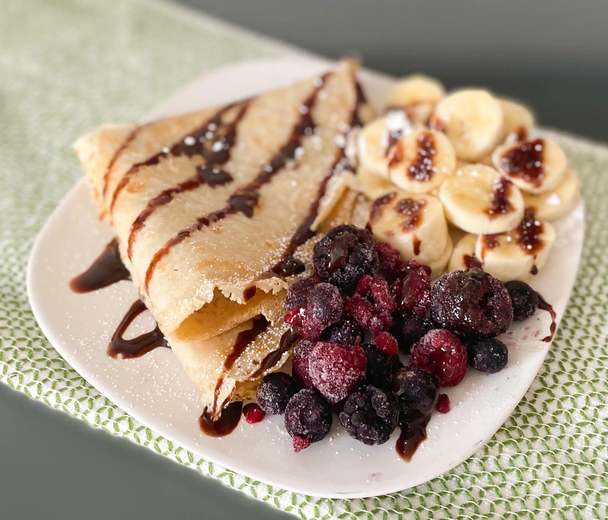 Sweet blini topped with fresh berries and honey 