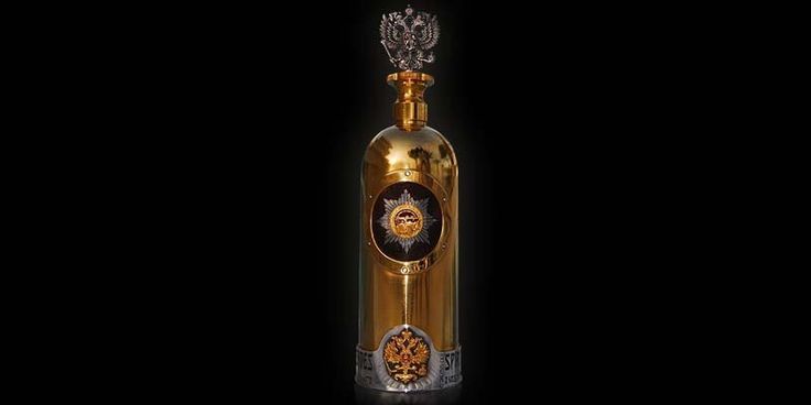 A bottle of Billionaire Vodka with gold and diamond accents.